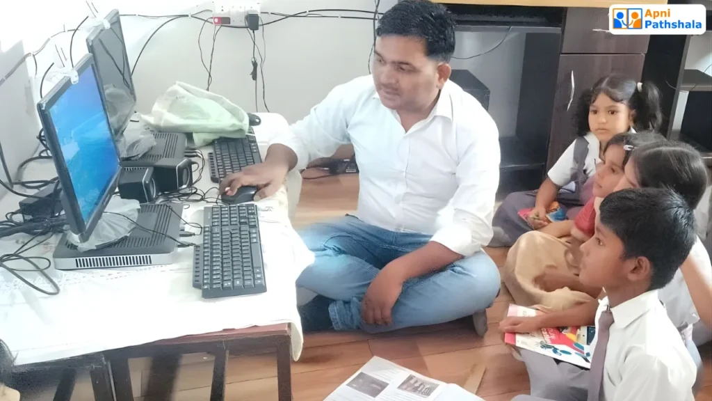 An Apni Pathshala facilitator teaching young children computer skills in a home-based learning pod, showing guided digital learning in the community.