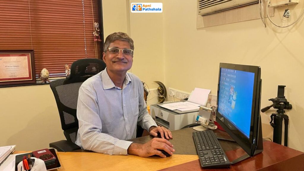 Dr. Aniruddha Malpani, founder of Apni Pathshala, working at his computer and leading the mission to provide meaningful digital access instead of free computers.