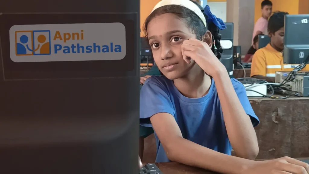 Girl watching a monitor at her learning space, showcasing self-learning and ACTiZENS quality in a single frame.