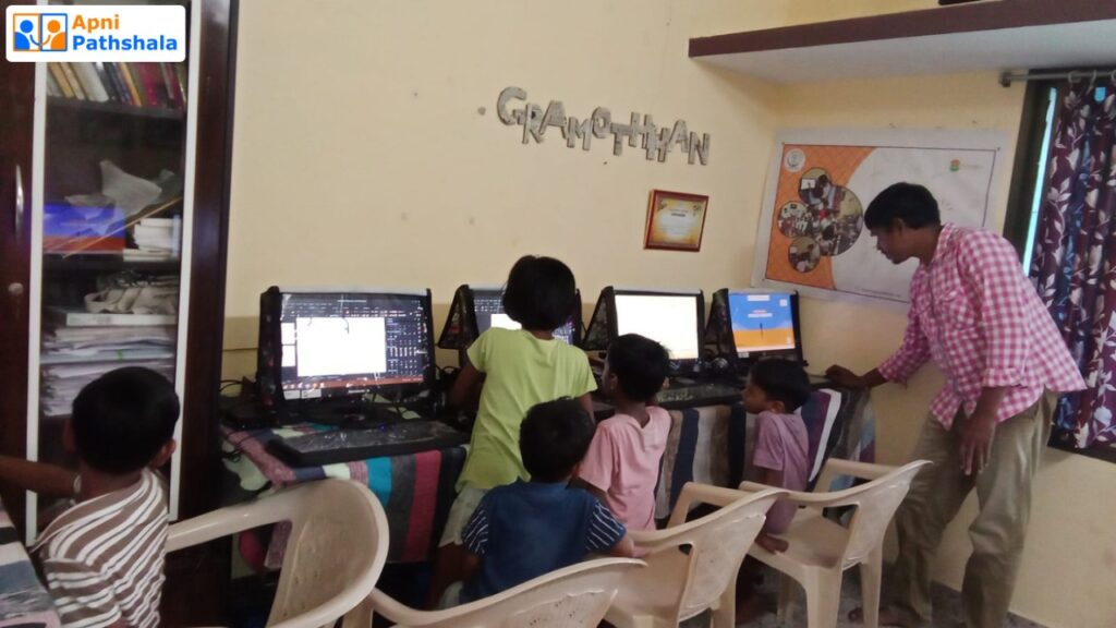 Students learning on Apni Pathshala computers inside a community POD classroom, demonstrating how partnership-based computer access works better than free computers.