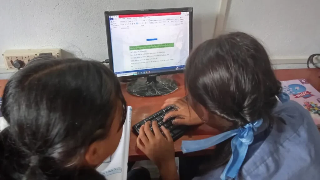 Two students collaborating on a digital assignment inside an Apni Pathshala Pod, practicing peer learning and teamwork.
