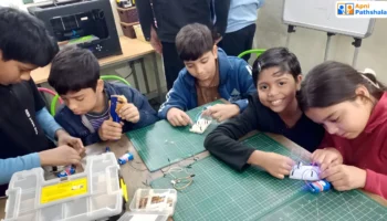 Students at an Apni Pathshala Learning Pod working on hands-on STEM projects, learning independently through exploration and creativity.